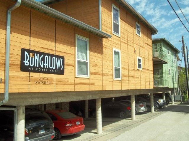 a front view of a building with parking area