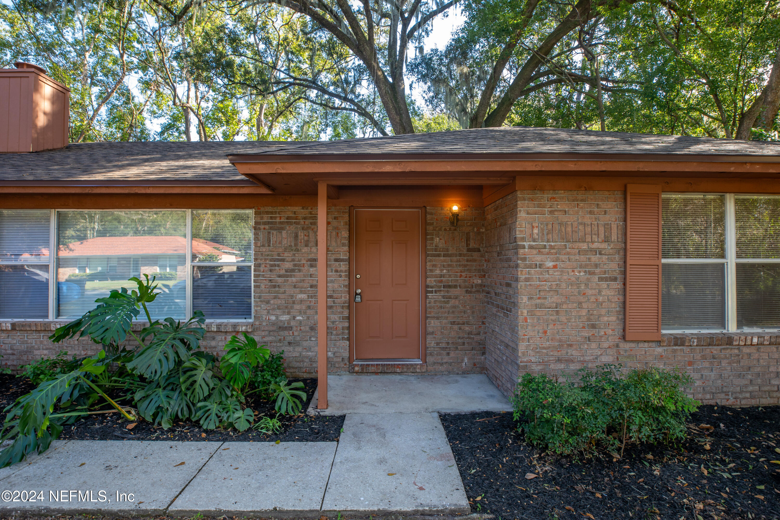 a side view of a house with a small yard