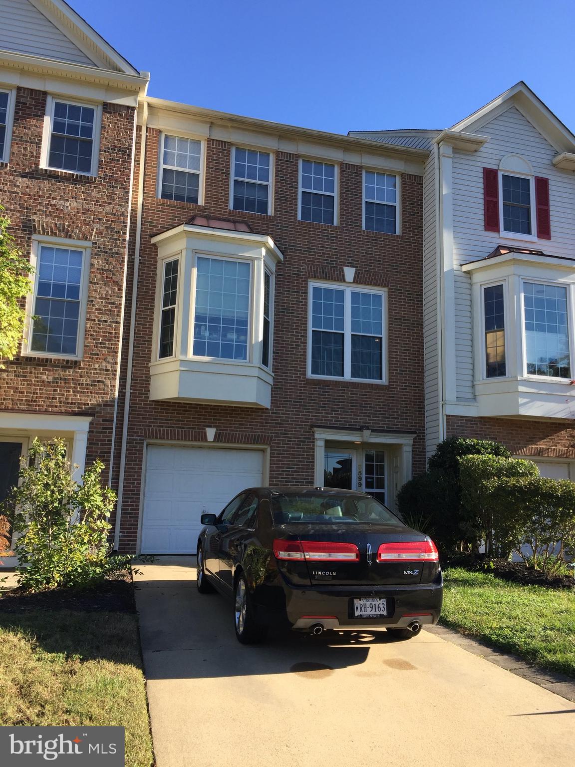 a car parked in front of a brick house