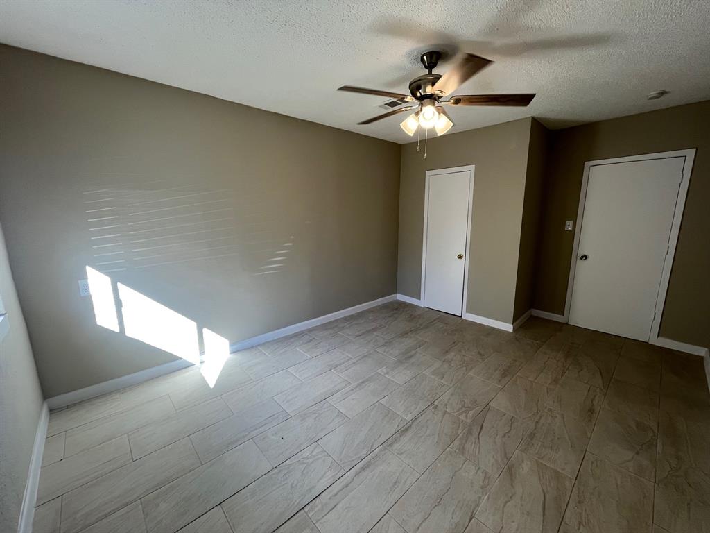 a view of a livingroom with a ceiling fan and window