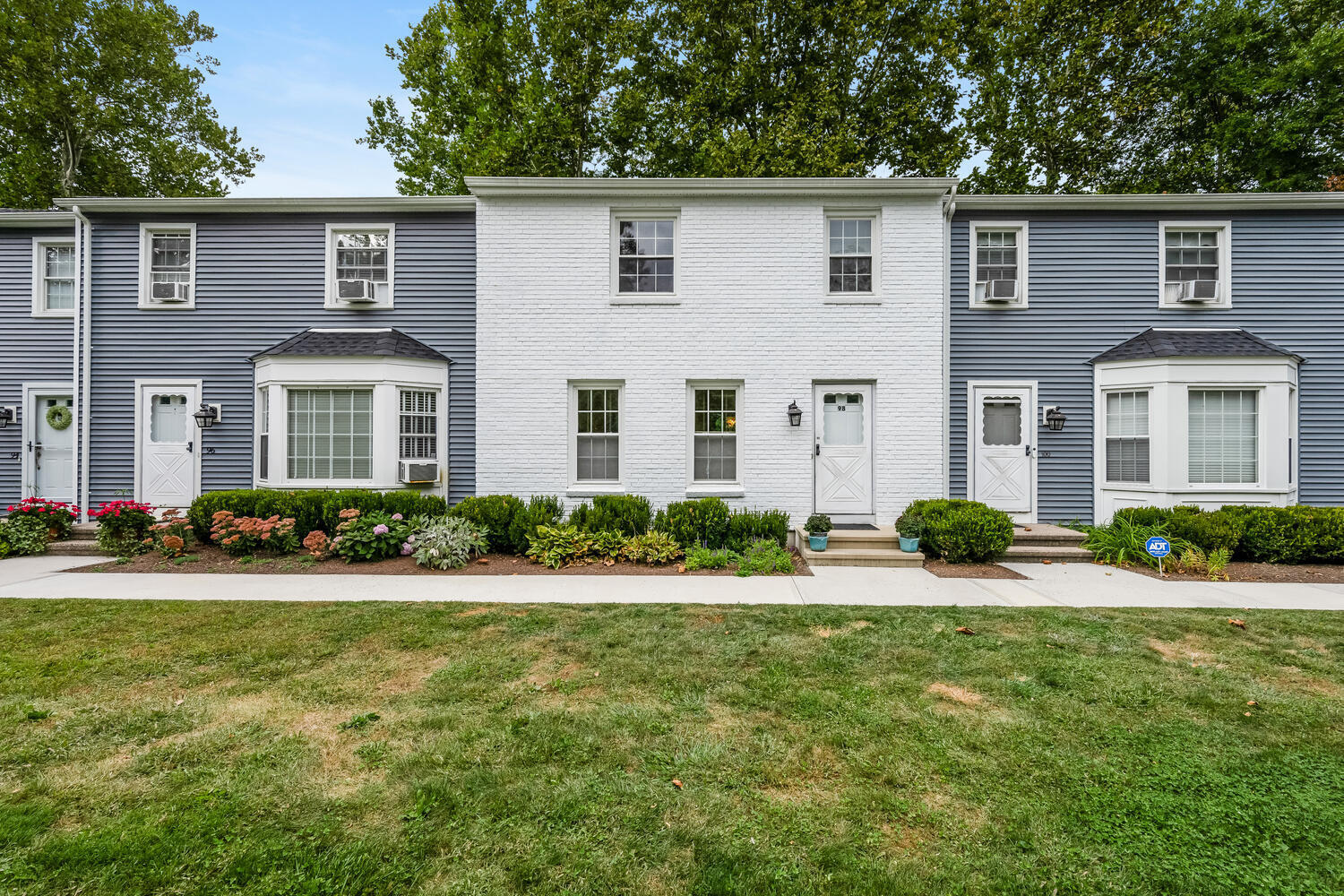 a front view of a house with yard and porch