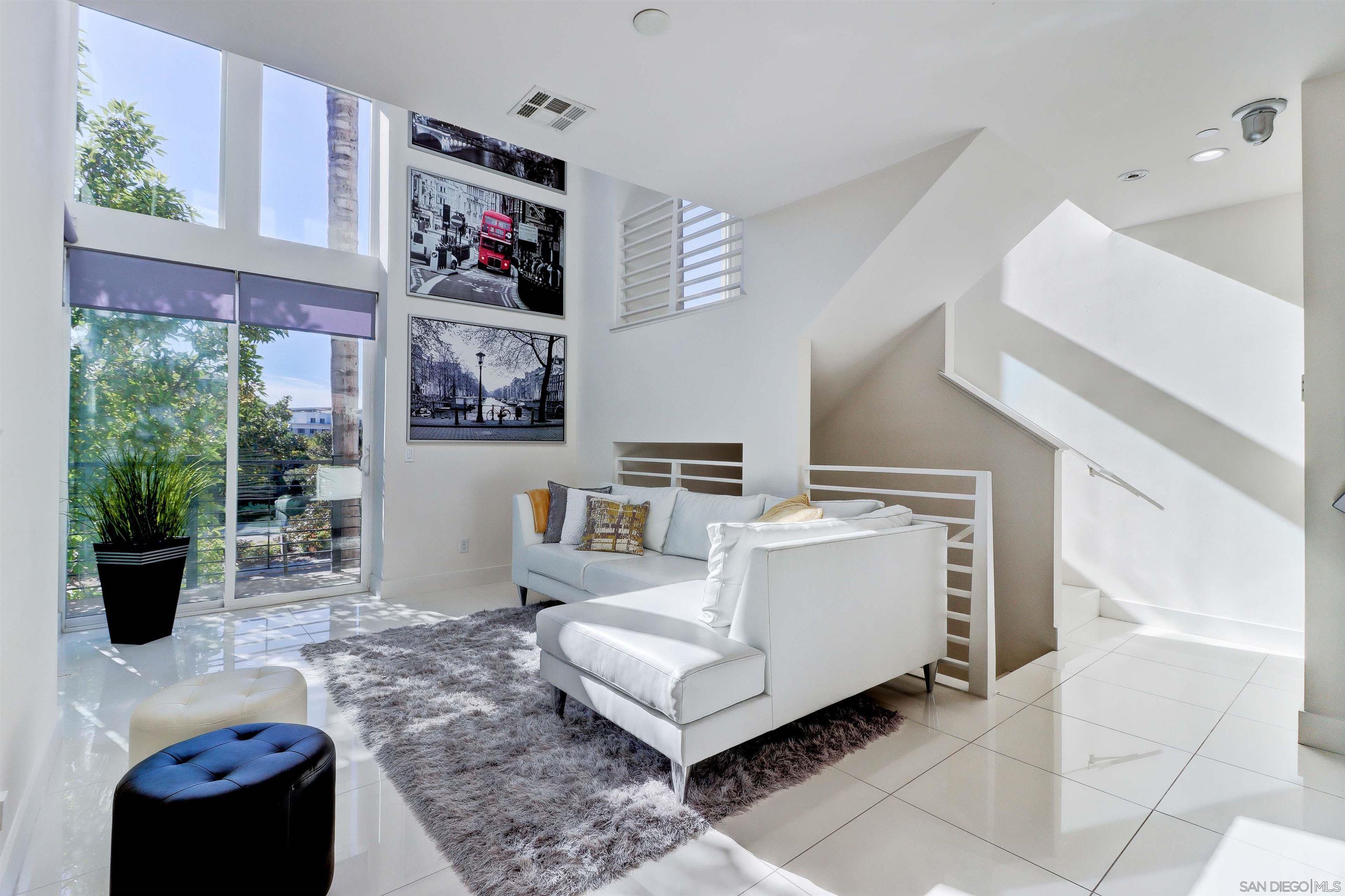 a living room with furniture and a painting on the wall