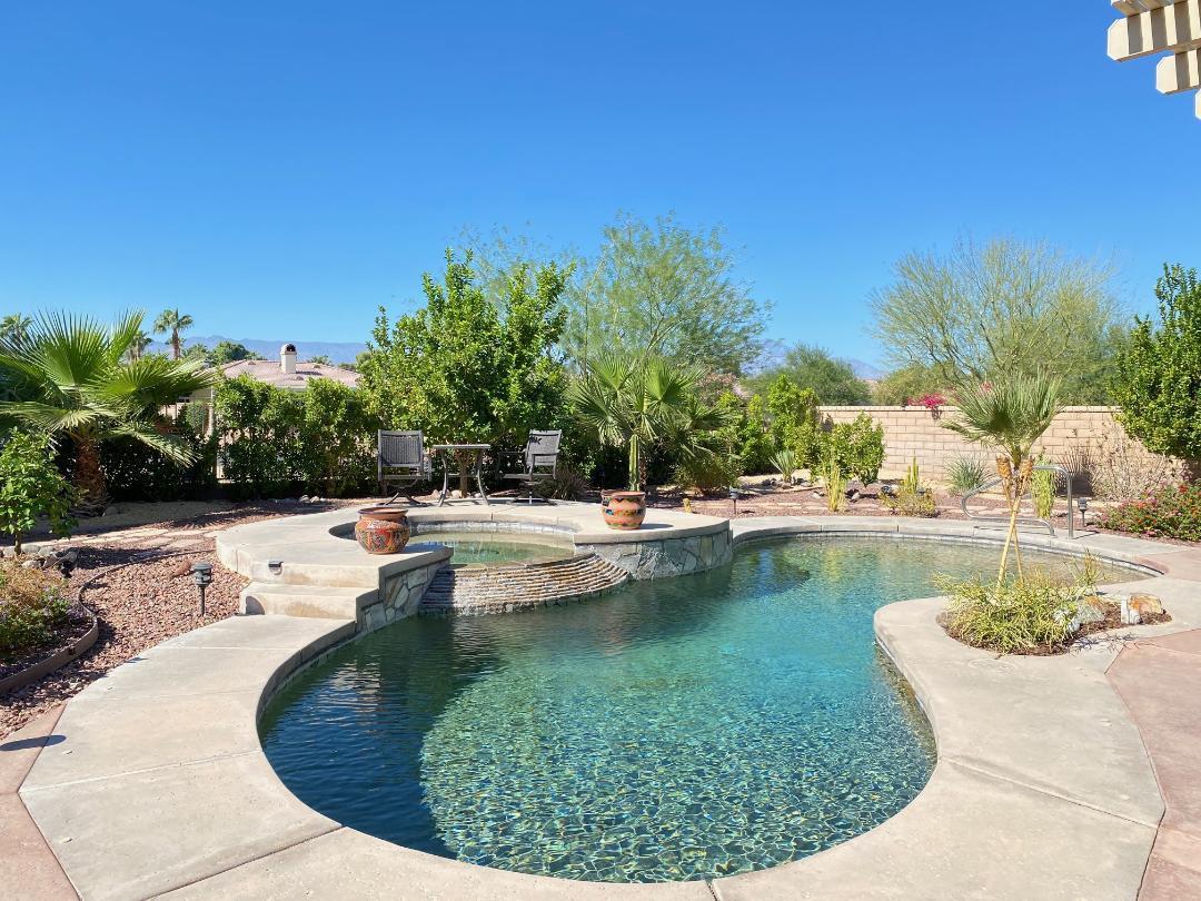 a view of a swimming pool with a yard