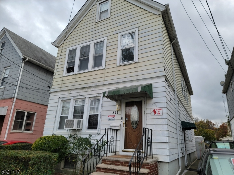 a front view of a house with stairs