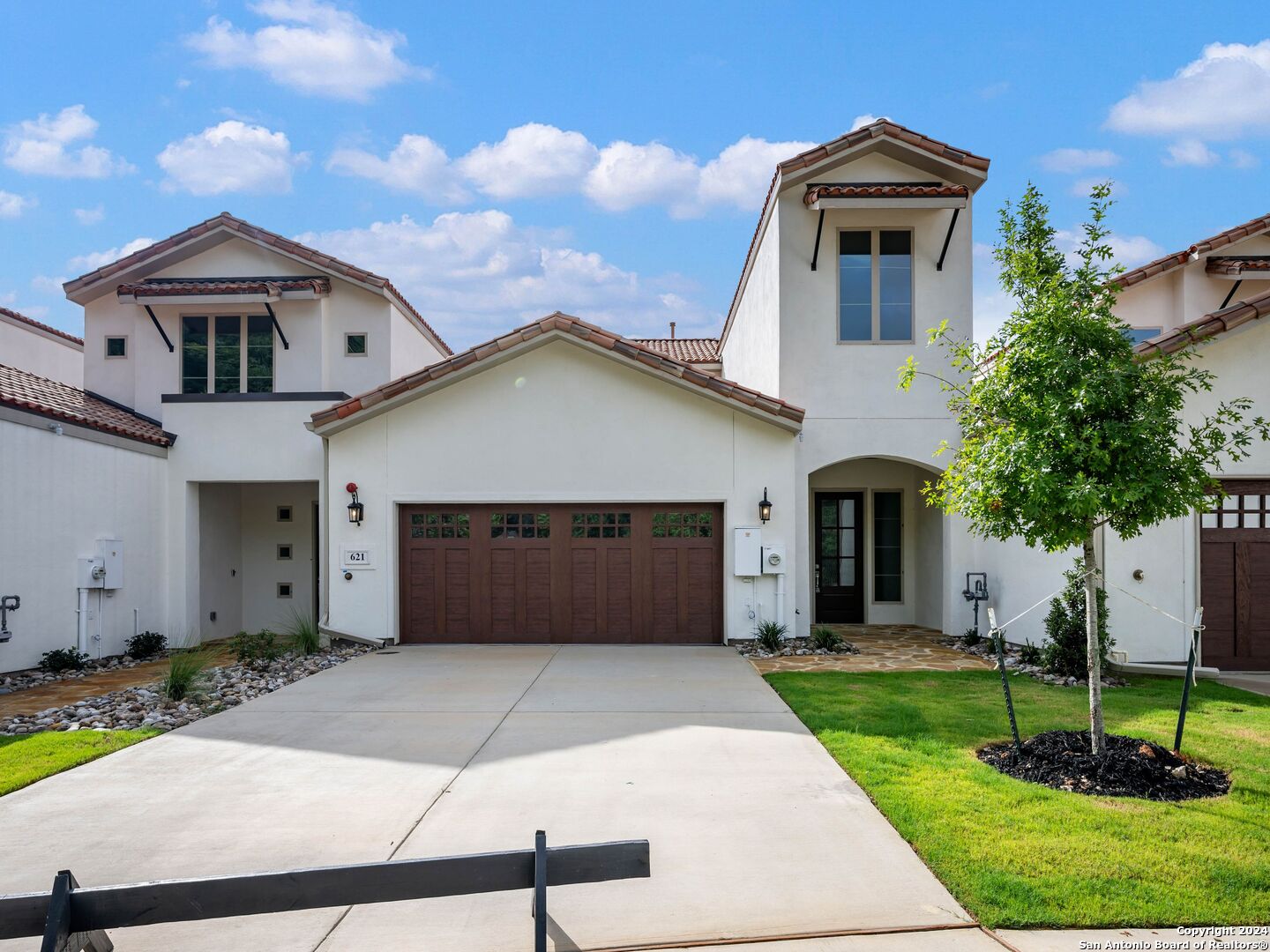 a front view of a house with a yard and garage