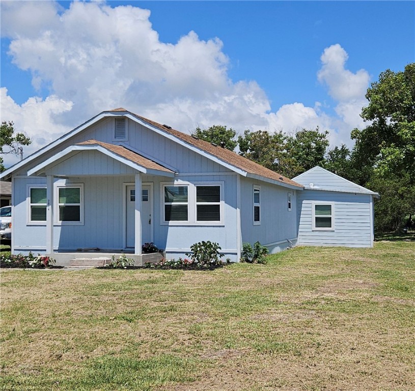 a view of a house with yard and sitting area