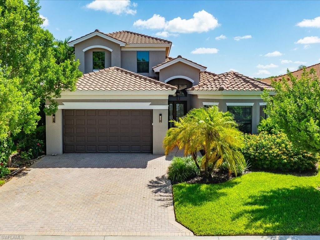 a front view of a house with a yard and garage