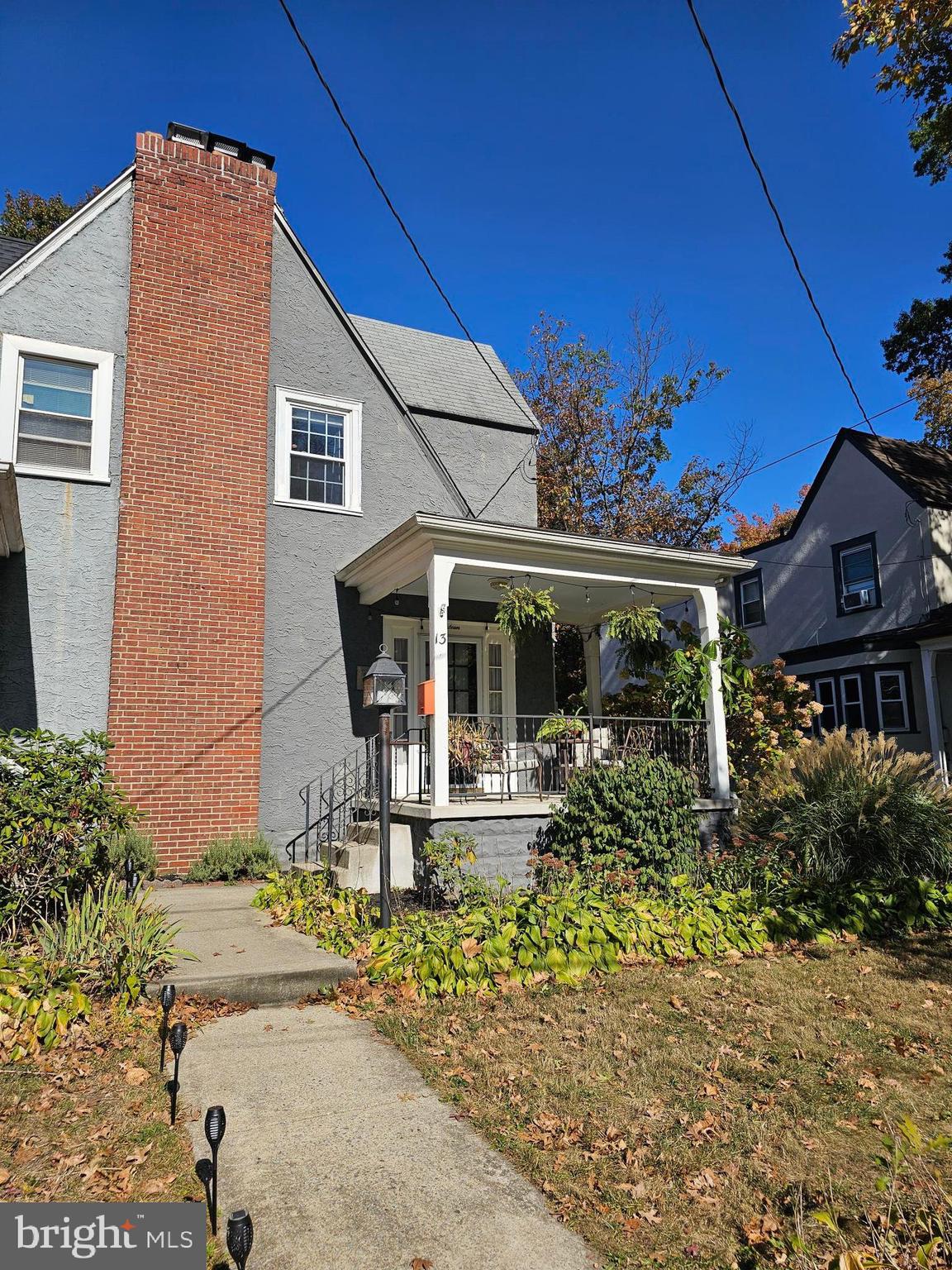 a front view of house with a garden