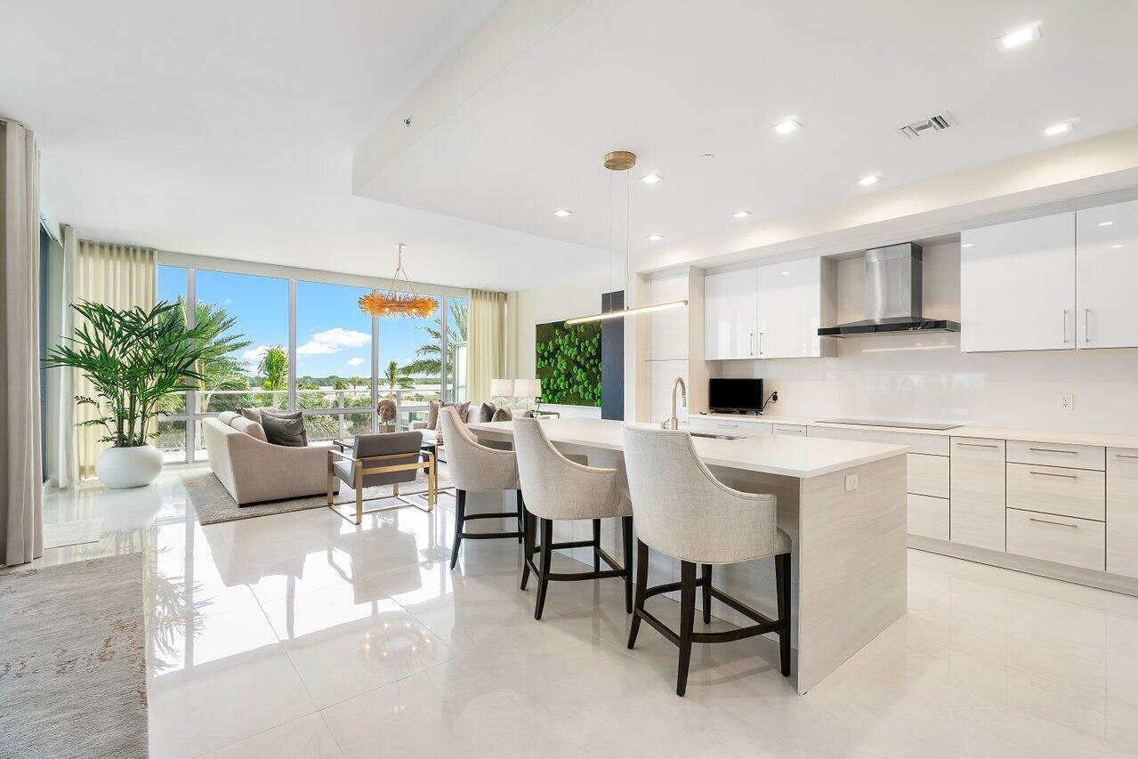 a kitchen with kitchen island granite countertop a table and chairs