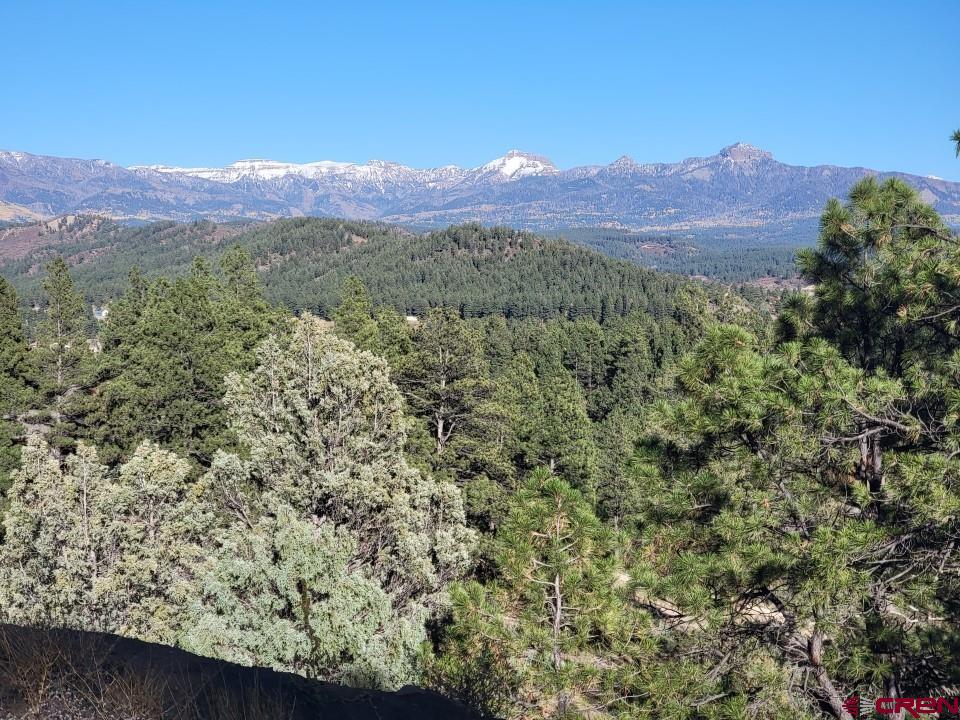 a view of a mountain range with a lush green hillside