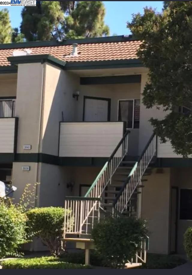 a view of house with roof deck and outdoor seating