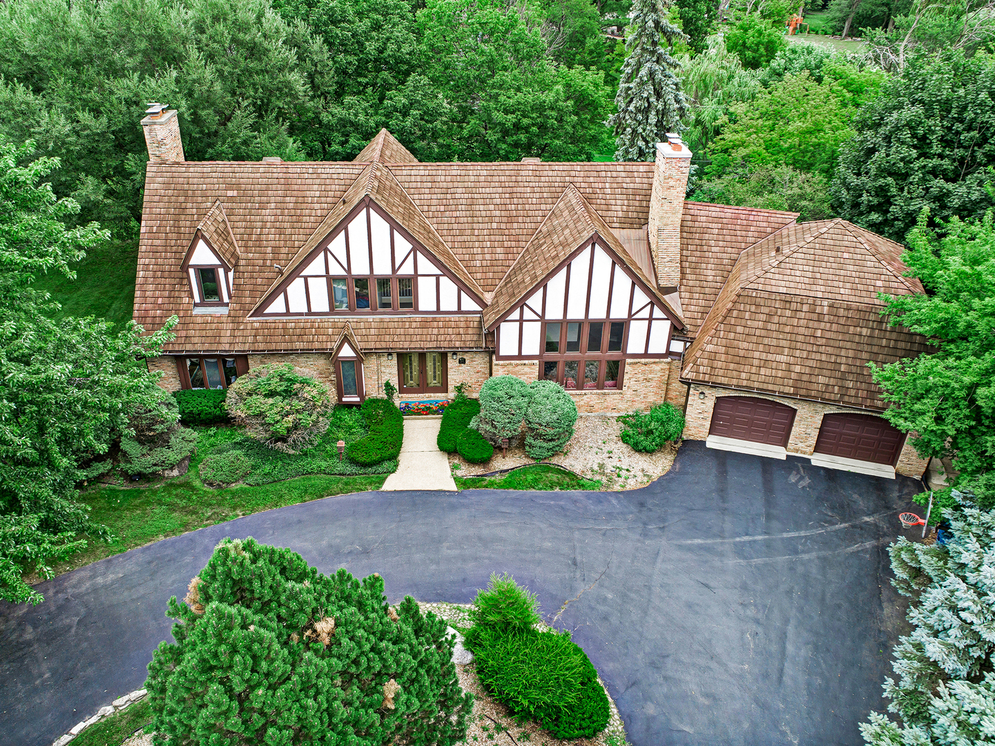 a aerial view of a house next to a yard