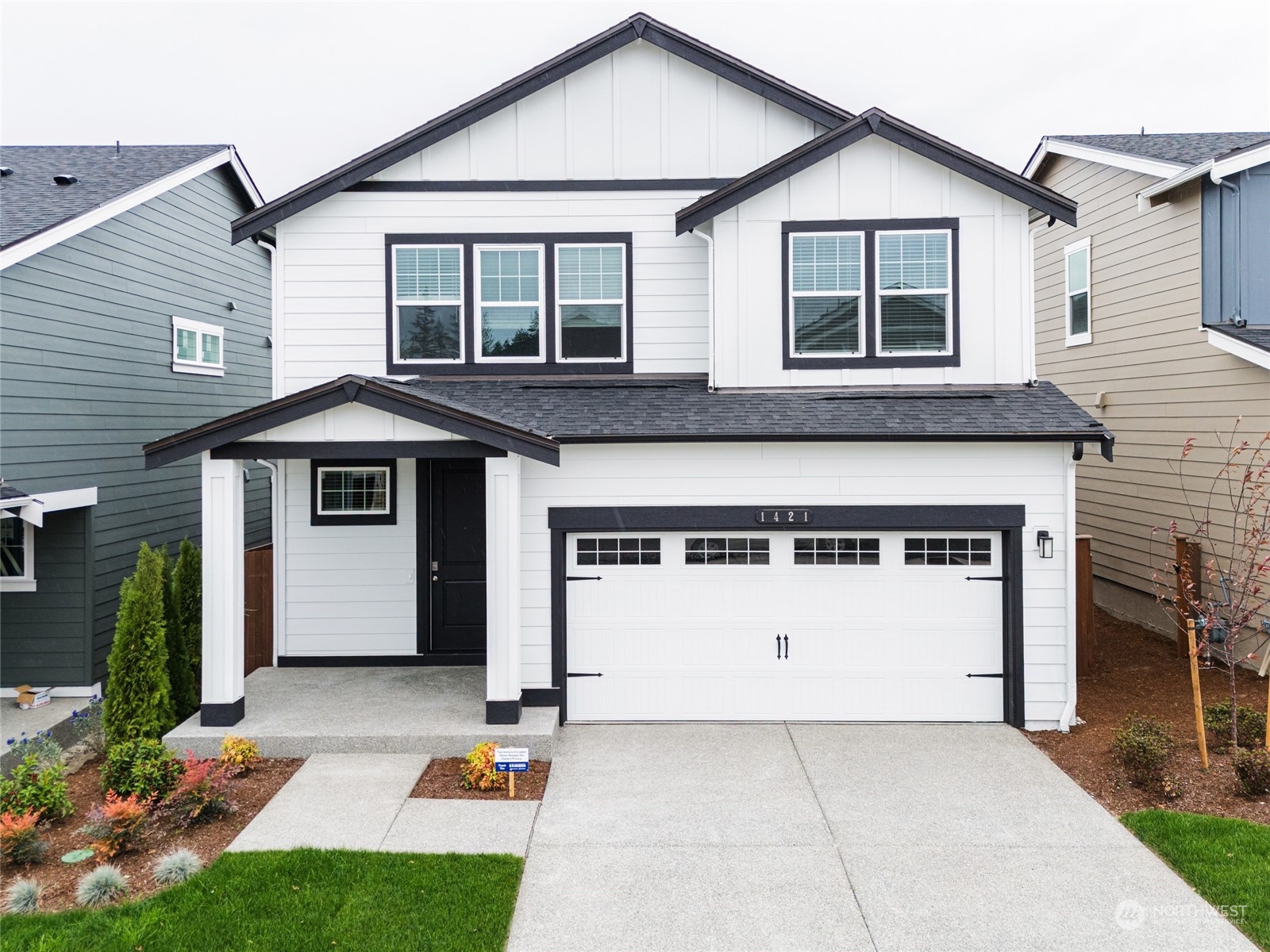 a front view of a house with a yard and garage