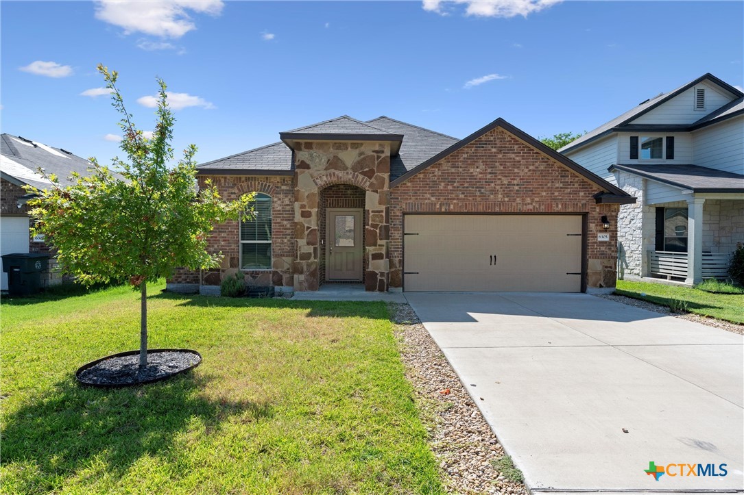 a front view of a house with a yard