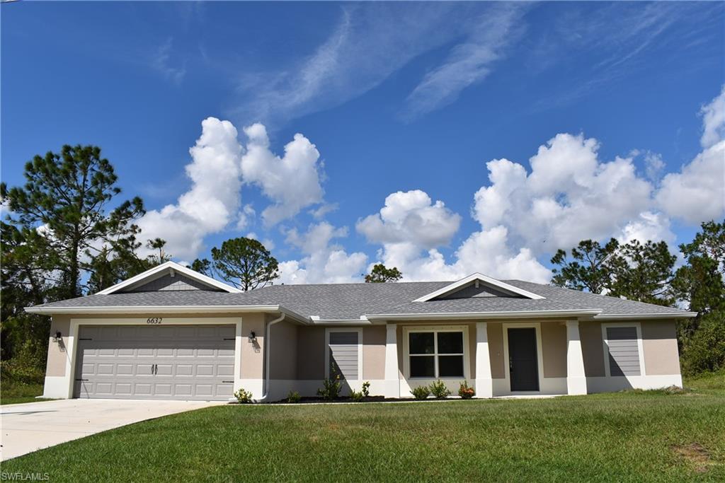 a front view of house with yard and green space