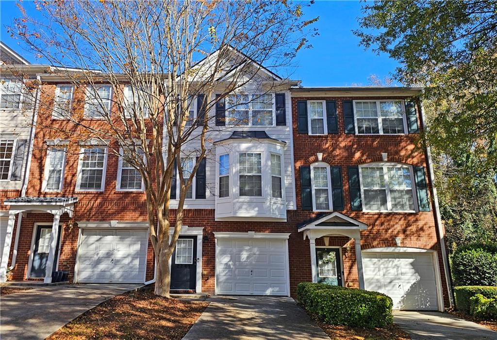 a front view of a residential apartment building with a yard