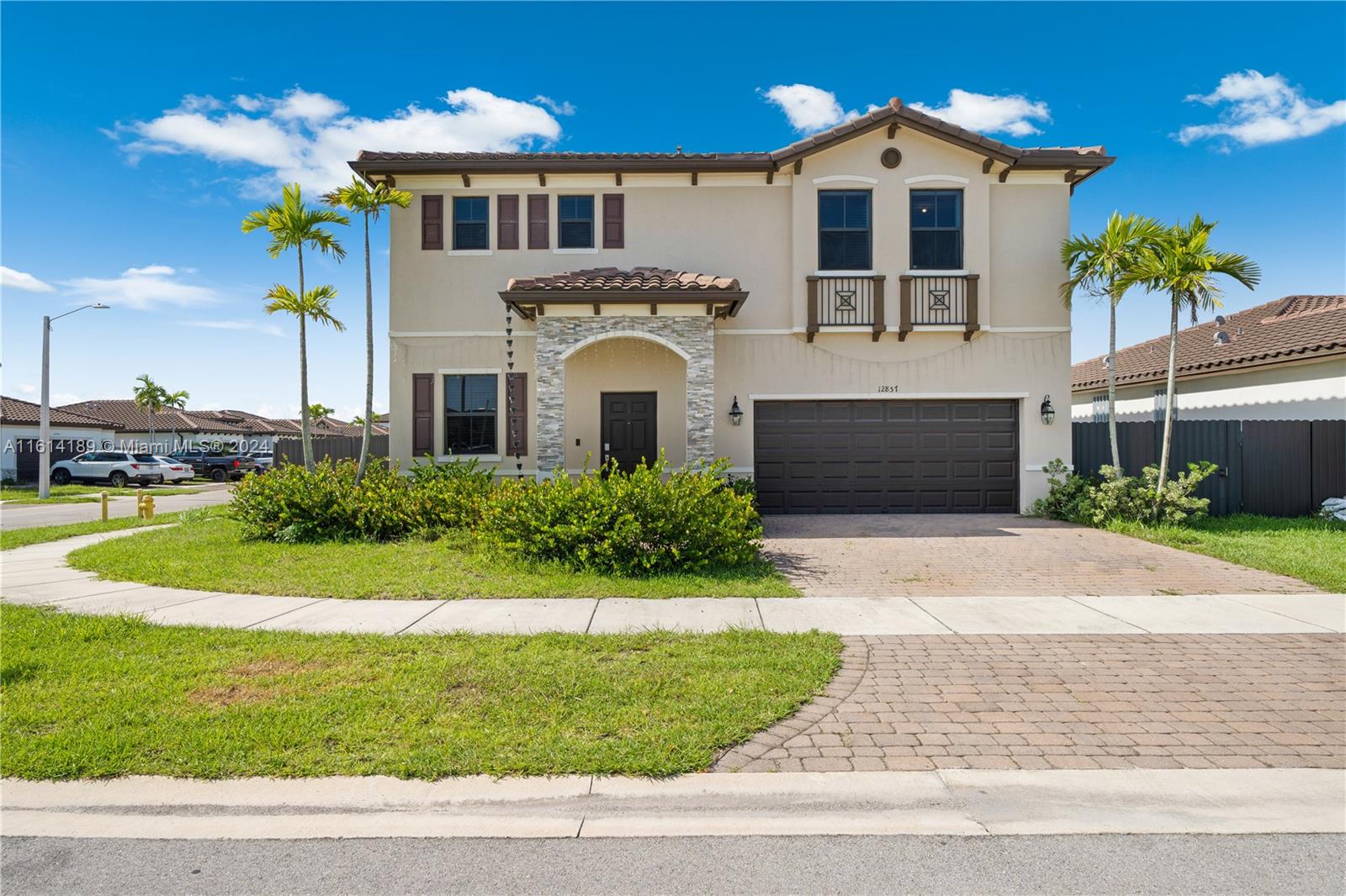 a front view of a house with a yard and garage