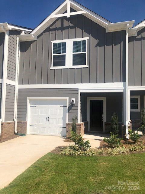 a front view of a house with a yard garage and outdoor seating