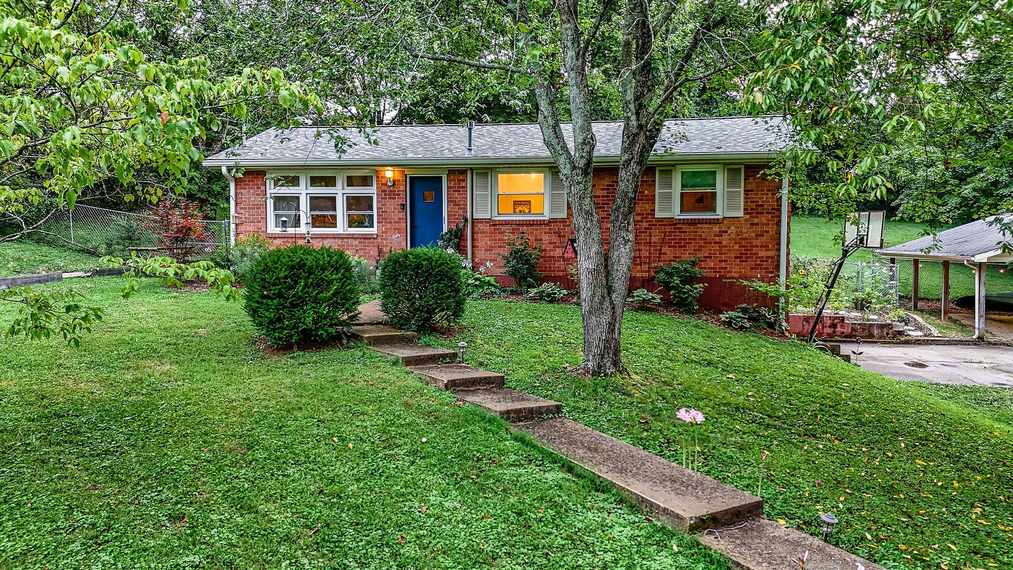 a view of a house with a backyard and a patio