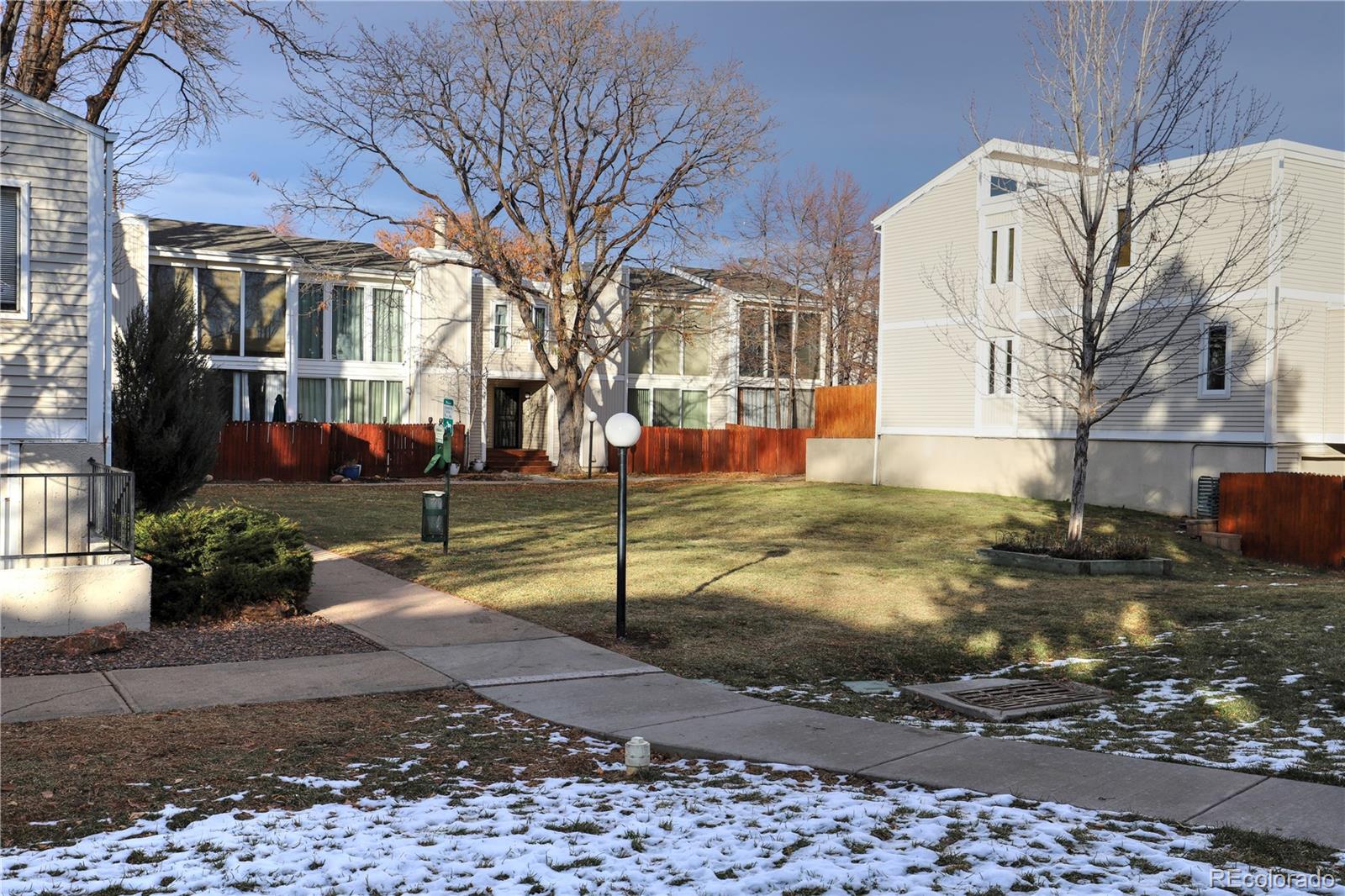 a view of a yard with a house in the background