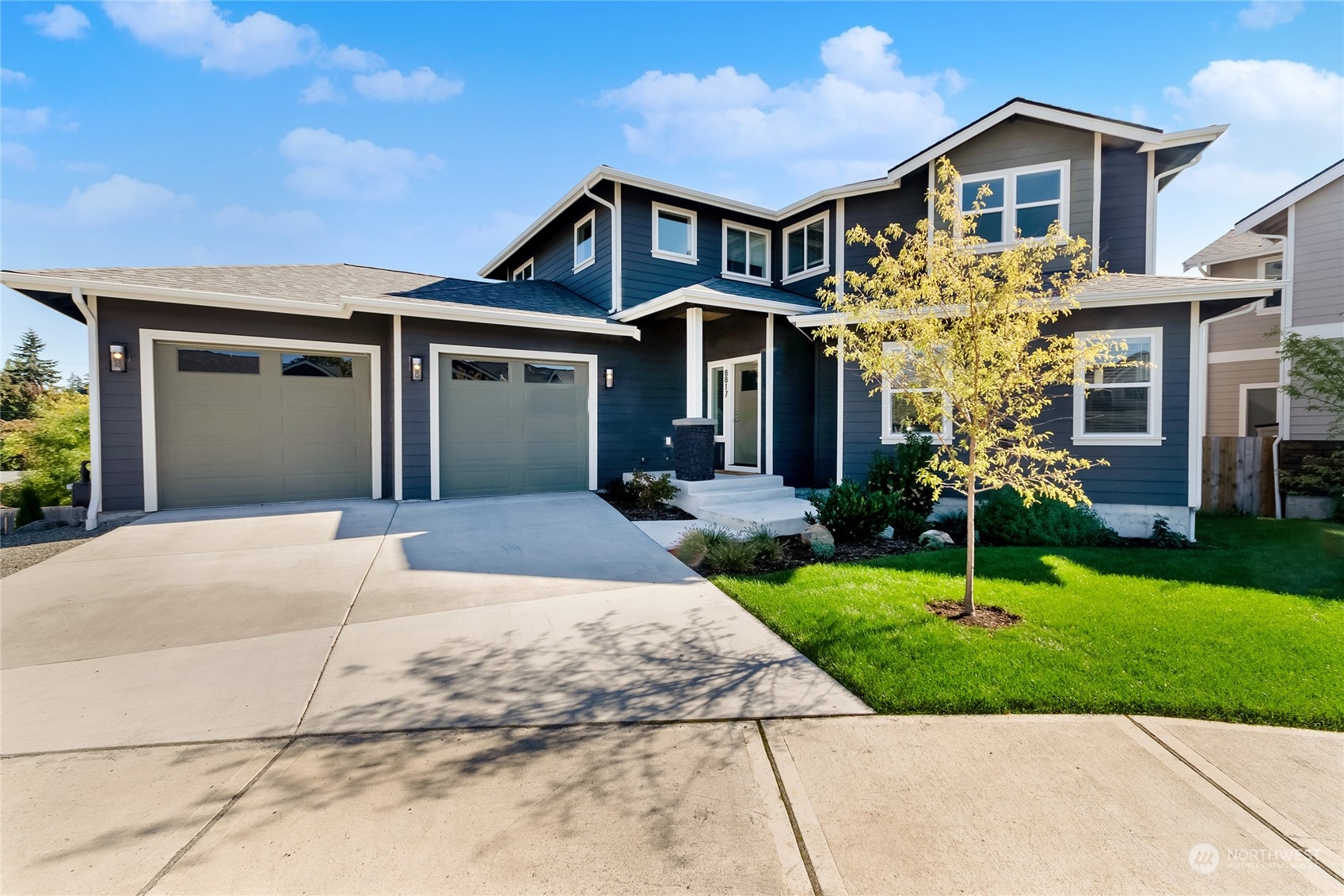 a front view of a house with a yard and garage