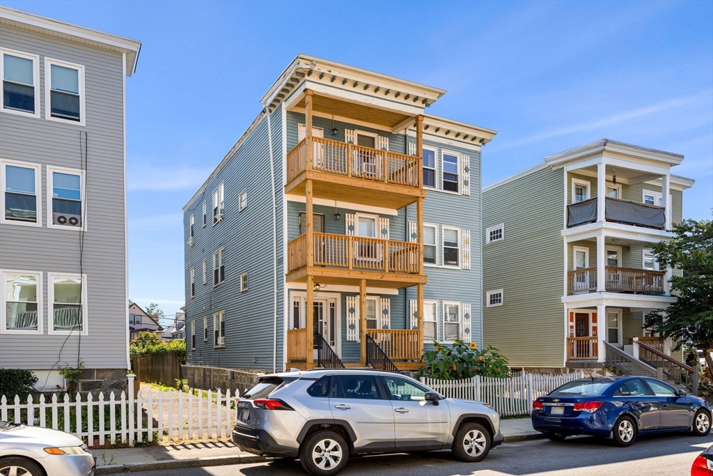 a front view of a residential apartment building with a parking space