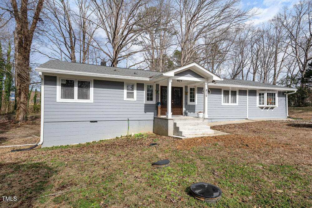 a front view of a house with yard and seating