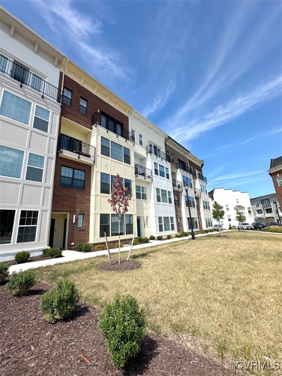 a front view of a building with a garden