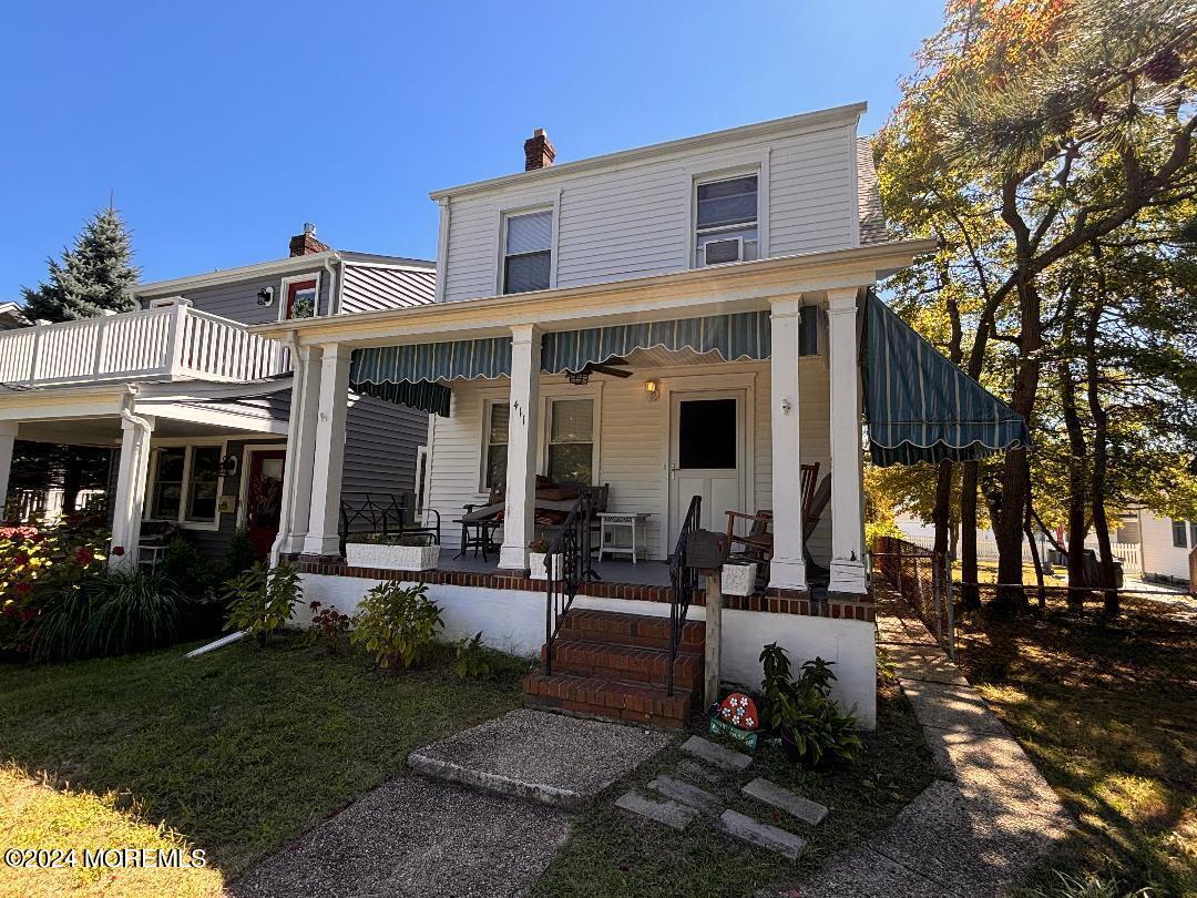 a view of a house with backyard porch and sitting area