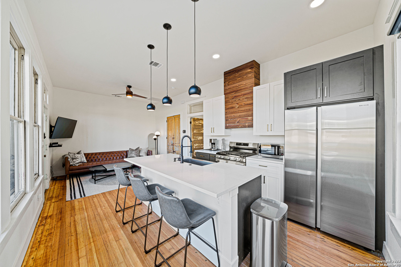 a kitchen with granite countertop a sink appliances a counter space and a window