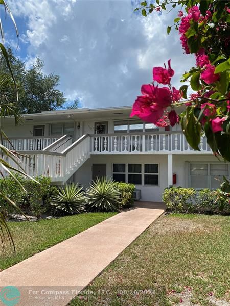 a front view of a house with a yard and a garage