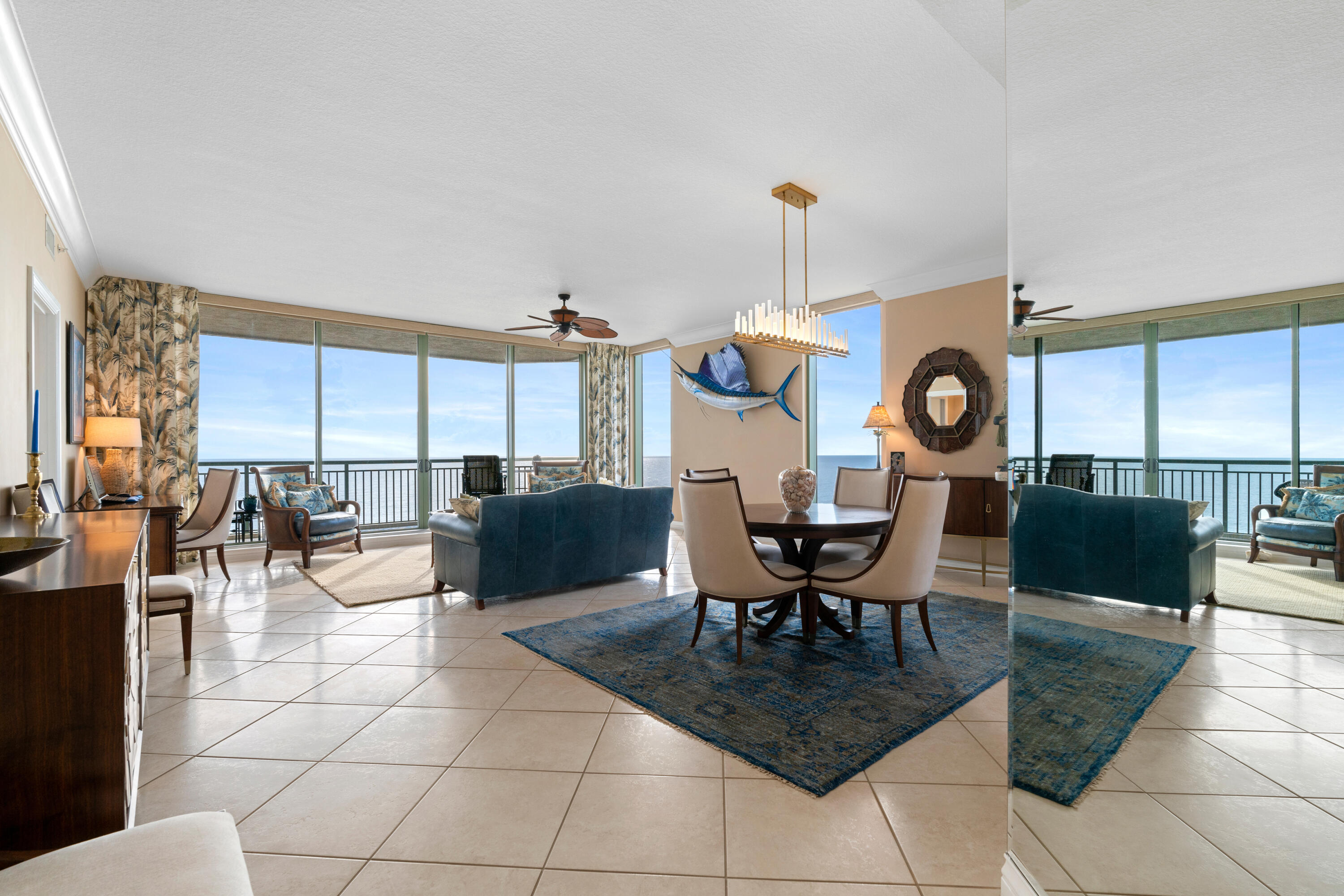 a living room with couches a dining table and chairs with outer view