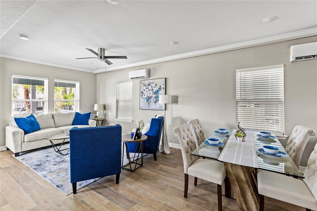 a living room with furniture a wooden floor and a window