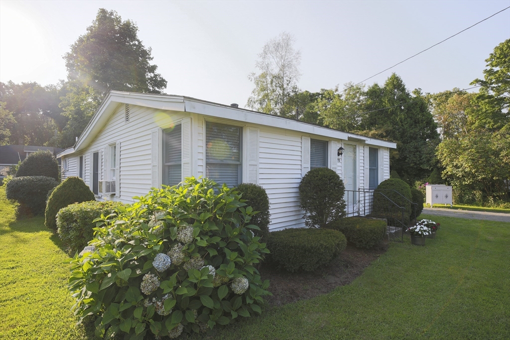 a view of a house with backyard and sitting area