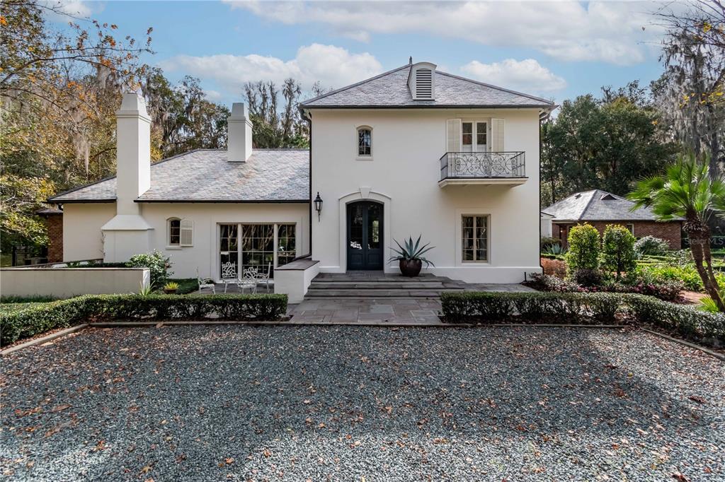 a front view of a house with a garden