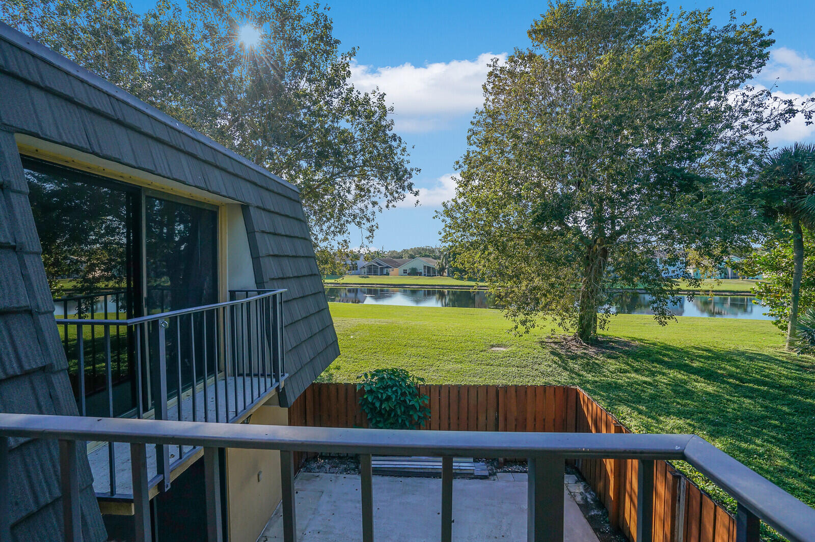 a view of a wooden deck and a garden