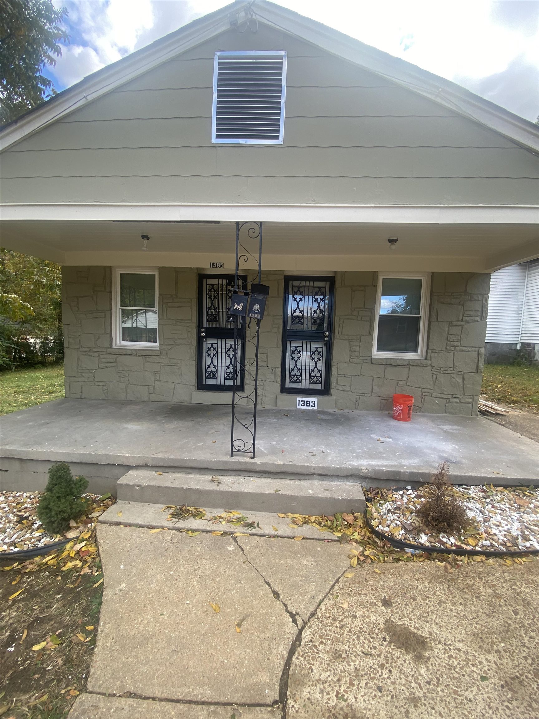 Entrance to property featuring covered porch