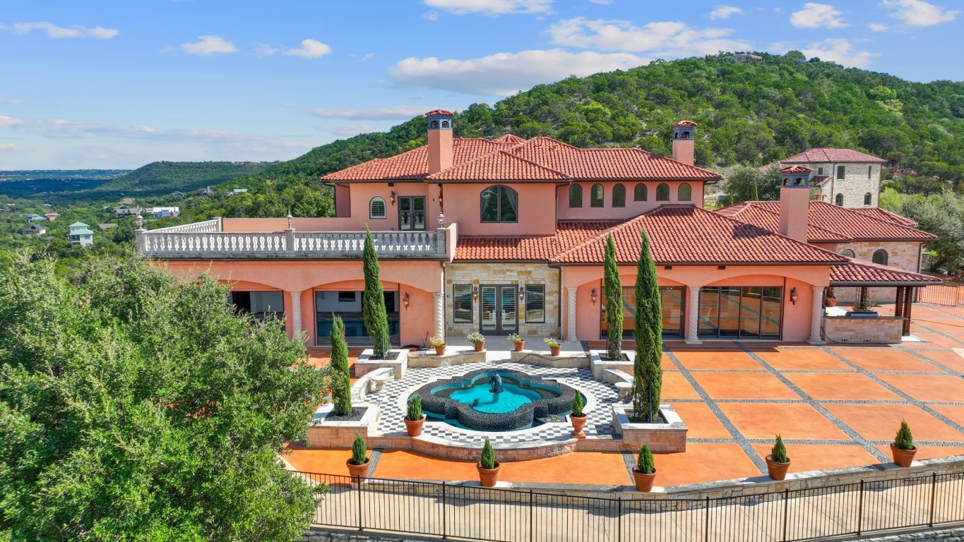 a aerial view of a house with yard and patio