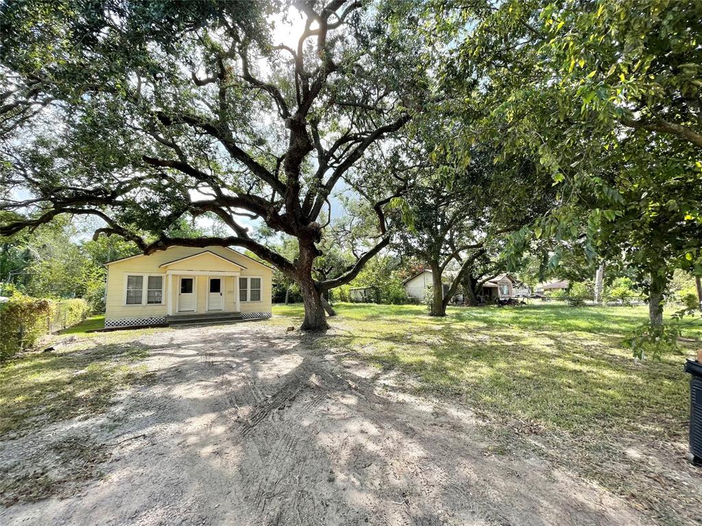 a front view of a house with a yard and trees