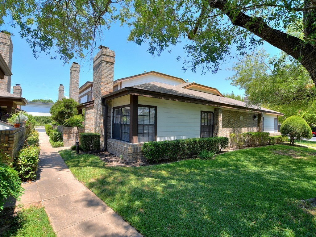 a front view of a house with garden