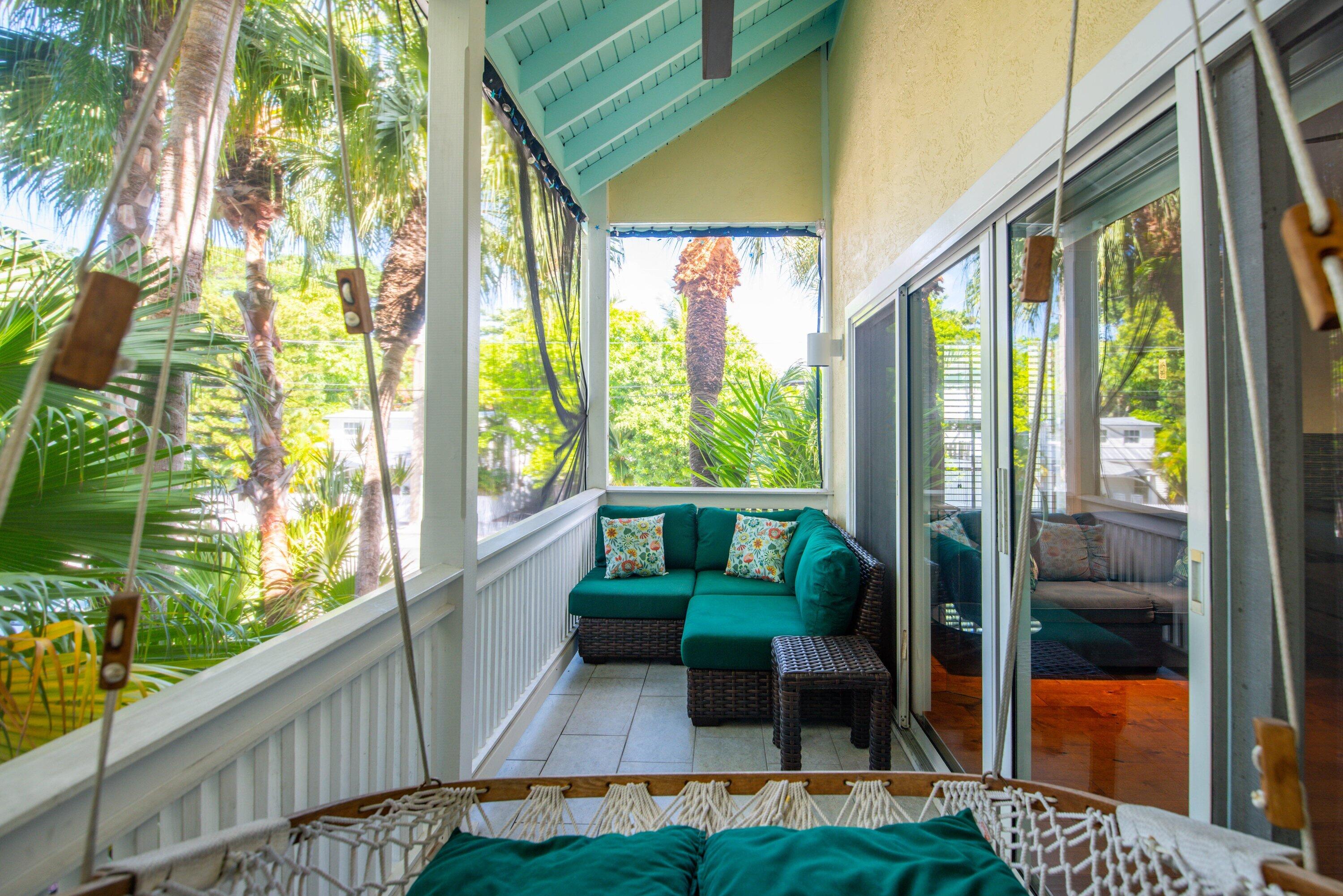 a balcony with furniture and a garden