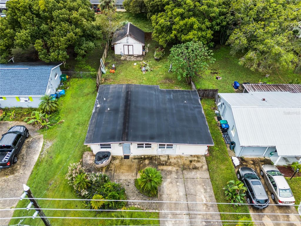 an aerial view of a house with garden space and street view