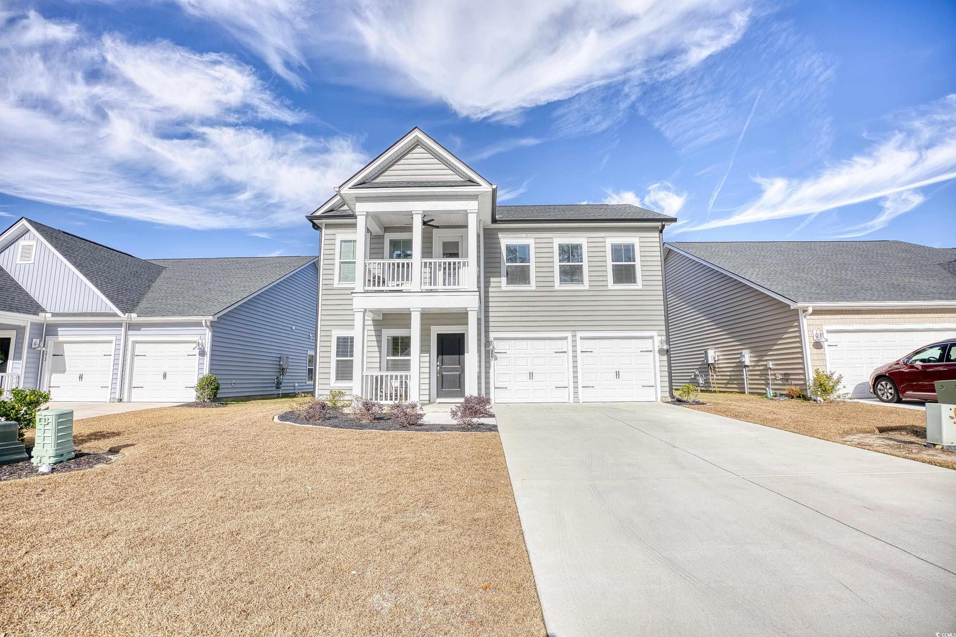 View of front of house with a porch, a balcony, a