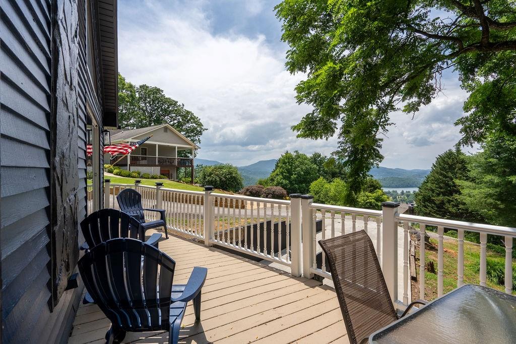 a view of a deck with two chair and wooden floor