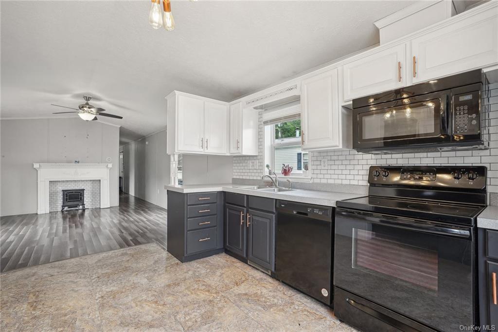 a kitchen with stainless steel appliances granite countertop a stove microwave and cabinets