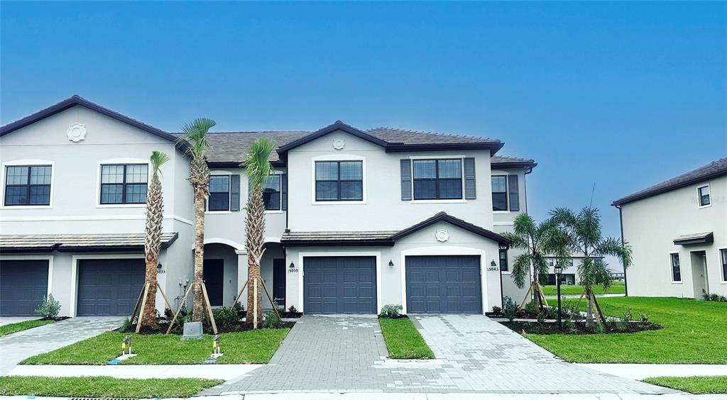 a front view of a house with a yard and garage