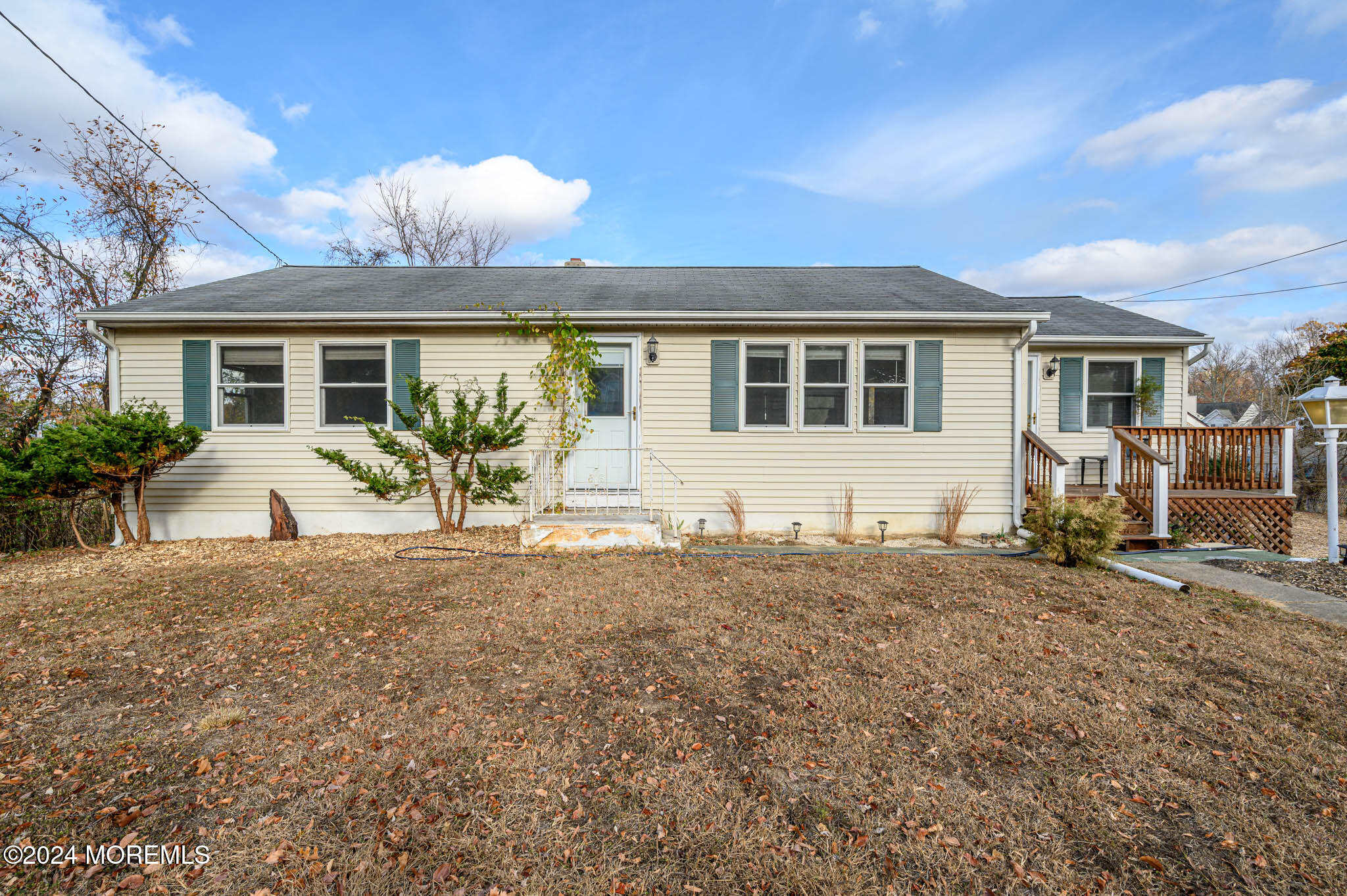 a front view of a house with yard and furniture