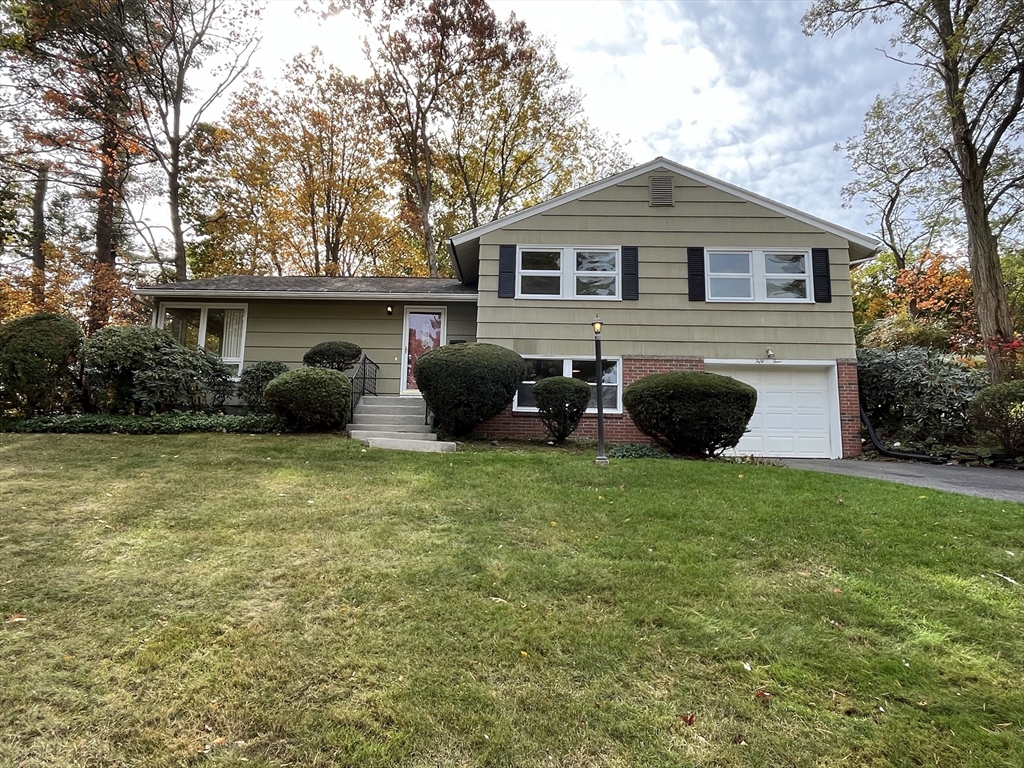 a front view of house with yard and outdoor seating