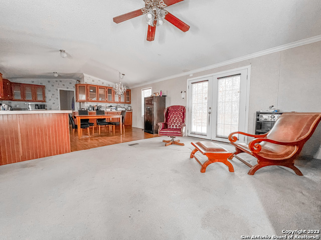 a living room with furniture a window and a chandelier