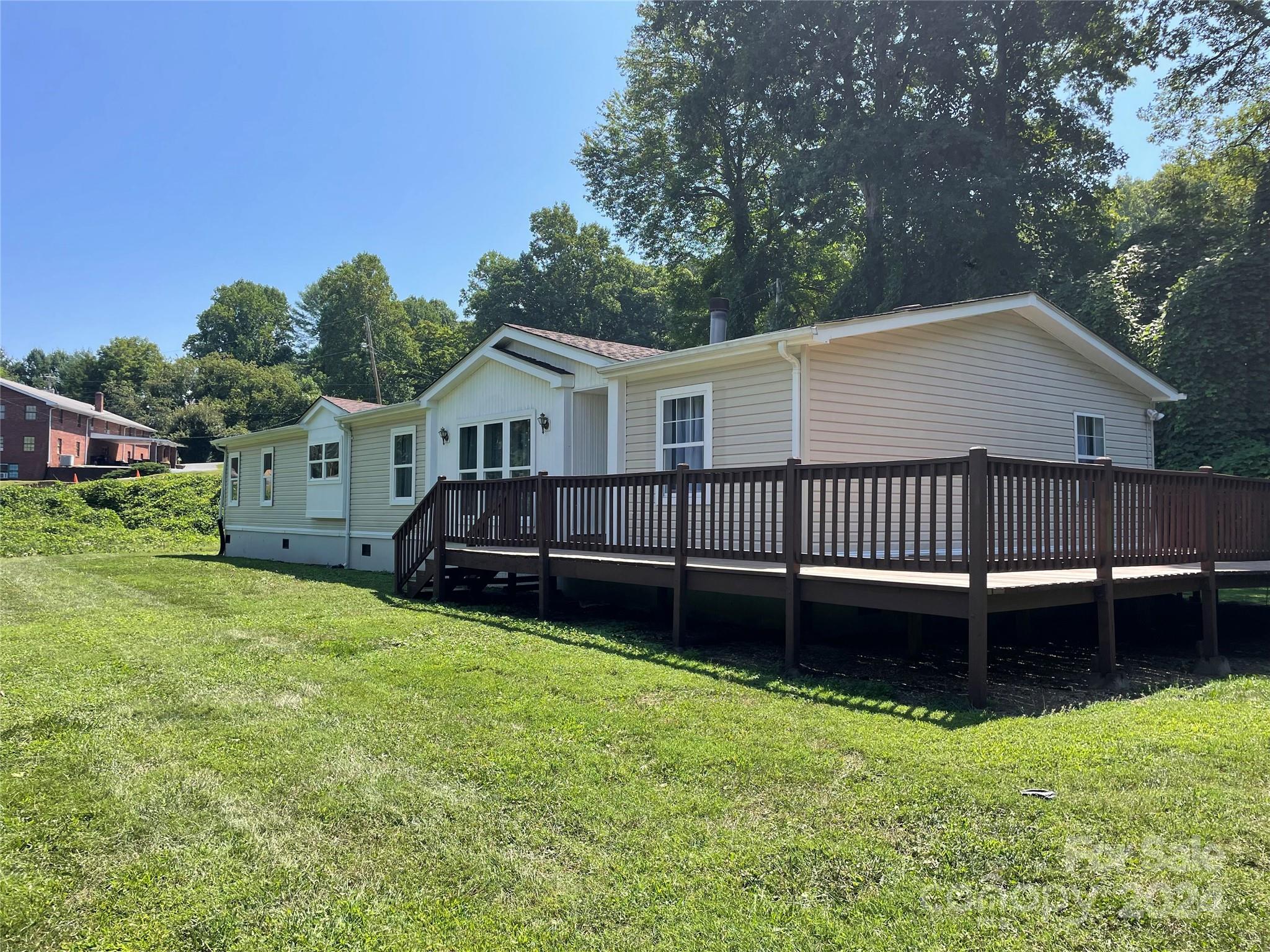 a view of a house with a yard and sitting area